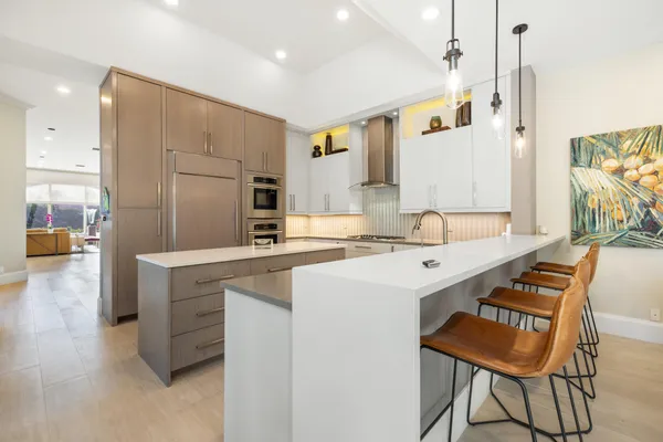 a kitchen with a sink and chairs