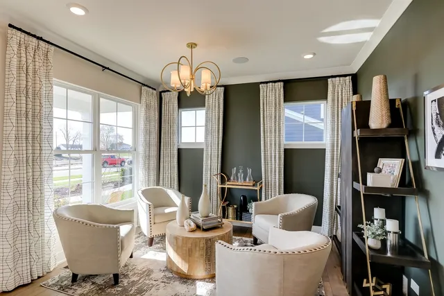 a living room with furniture a chandelier and a large window