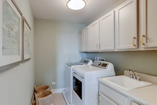 a utility room with sink dryer and washer
