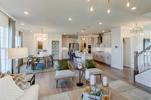 a living room with lots of furniture and kitchen view