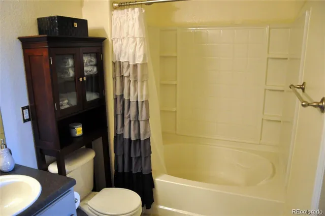a bathroom with a toilet a sink and shower