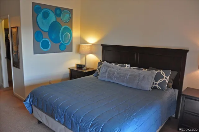 a bedroom with a bed and lamp