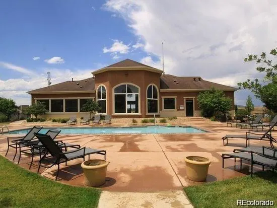 a view of a house with swimming pool and sitting area
