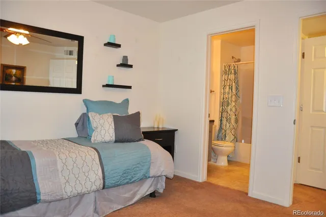 a bedroom with a bed and a mirror