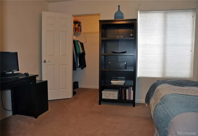 a bedroom with a bed and a television