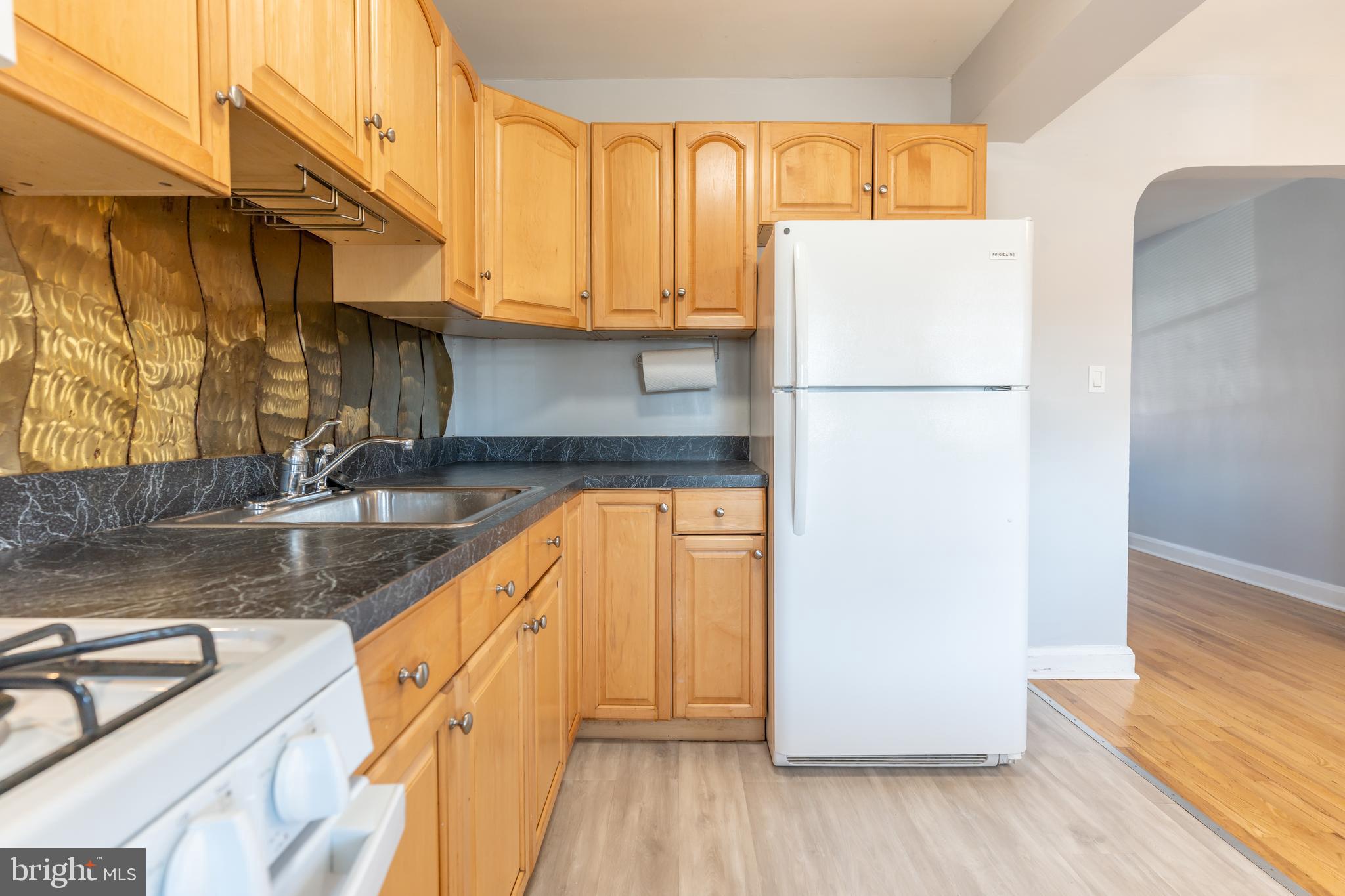 577 Welbrook Road Baltimore, MD 21221 - Photo 13 of 31 a view of a kitchen with wooden floor and a sink