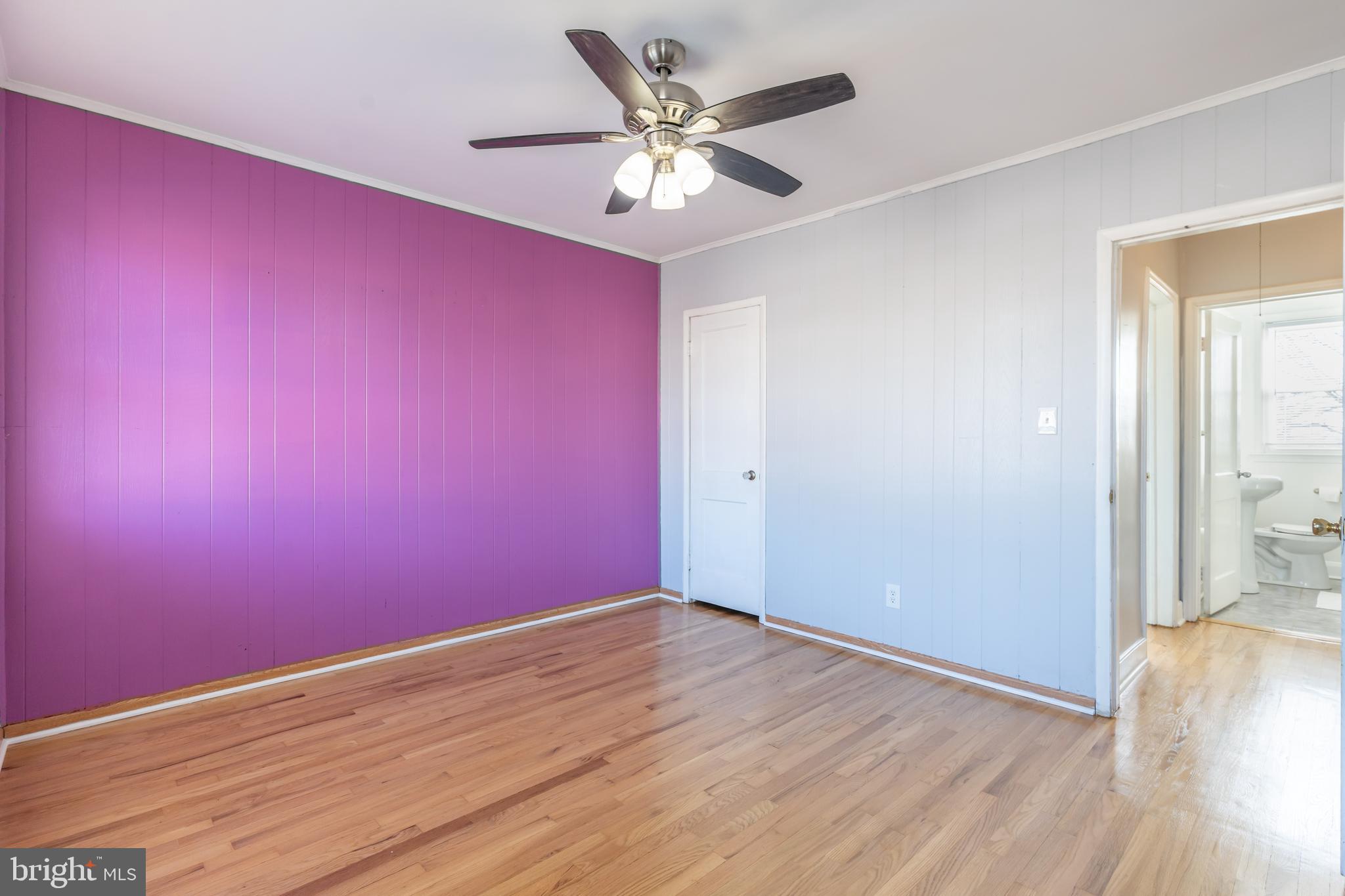 577 Welbrook Road Baltimore, MD 21221 - Photo 18 of 31 an empty room with wooden floor and a ceiling fan