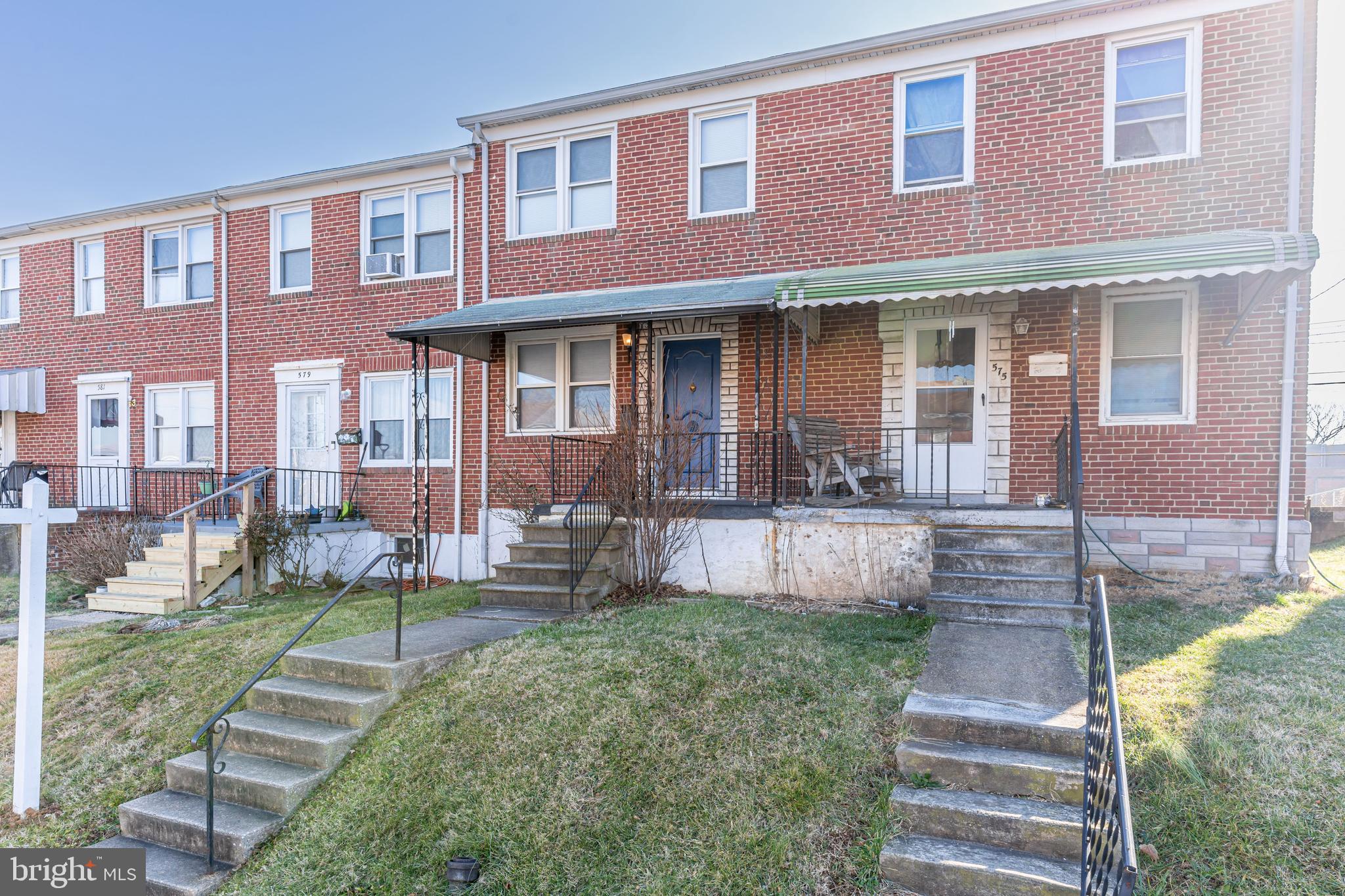 577 Welbrook Road Baltimore, MD 21221 - Photo 3 of 31 a front view of a brick house with a yard and plants