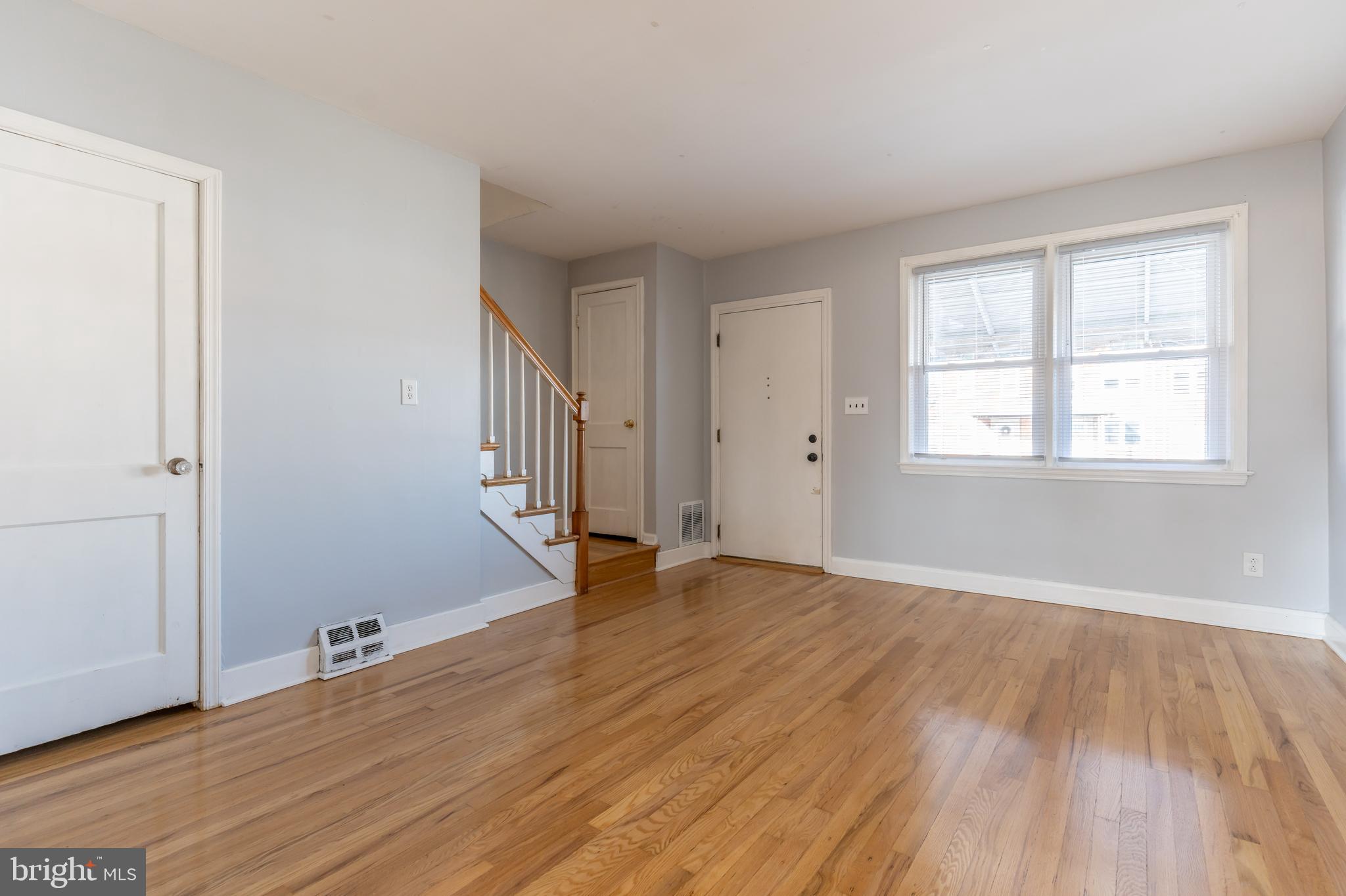 577 Welbrook Road Baltimore, MD 21221 - Photo 5 of 31 a view of an empty room with wooden floor and a window