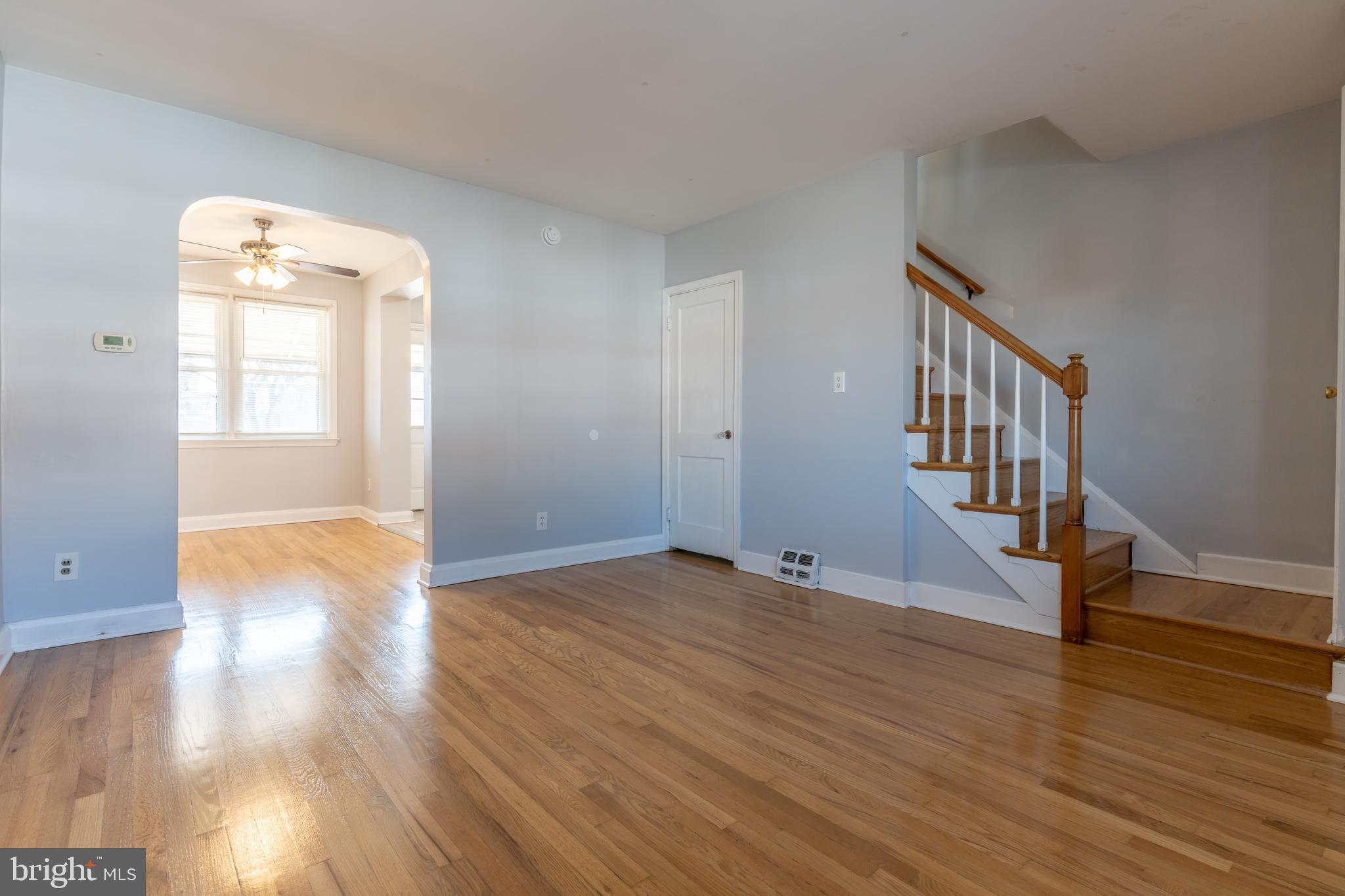 577 Welbrook Road Baltimore, MD 21221 - Photo 7 of 31 a view of an empty room with wooden floor and a window