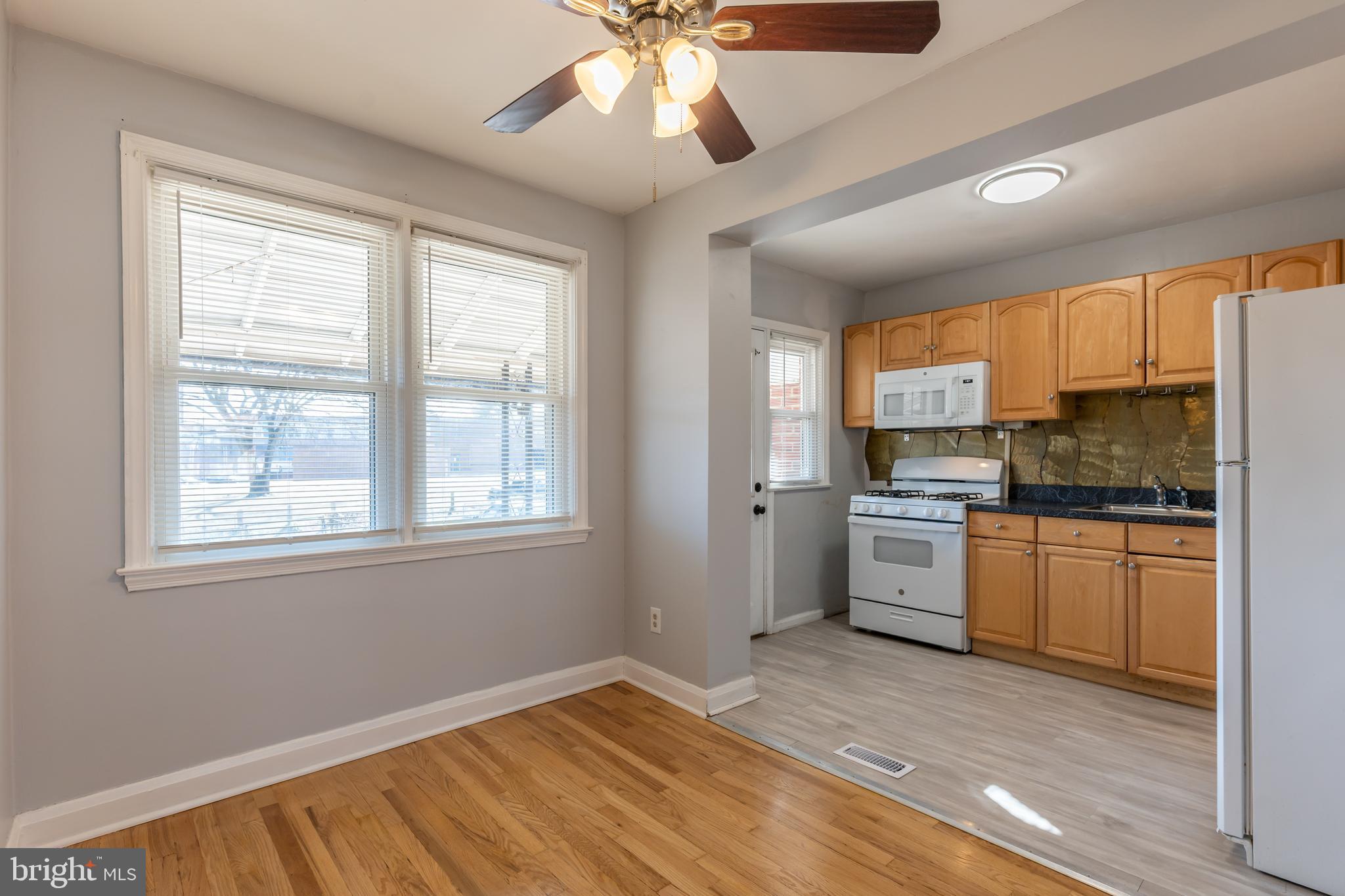 577 Welbrook Road Baltimore, MD 21221 - Photo 9 of 31 a kitchen with stainless steel appliances granite countertop a stove cabinets and a refrigerator