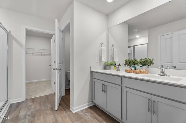 an empty room with windows and ceiling fan