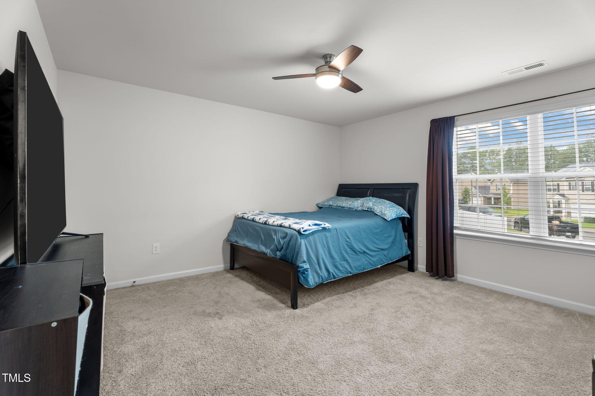 132 Rockfall Way Rocky Mount, NC 27803 - Photo 19 of 51 a spacious bedroom with a bed and a flat tv screen on the dresser