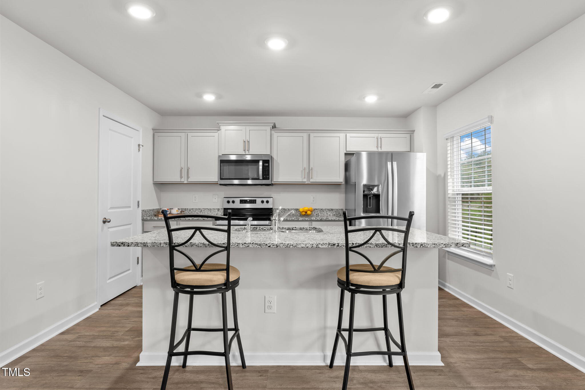 132 Rockfall Way Rocky Mount, NC 27803 - Photo 35 of 51 a kitchen with stainless steel appliances kitchen island granite countertop a refrigerator and microwave
