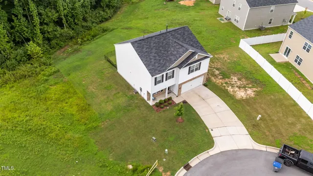 aerial view of a house with a yard