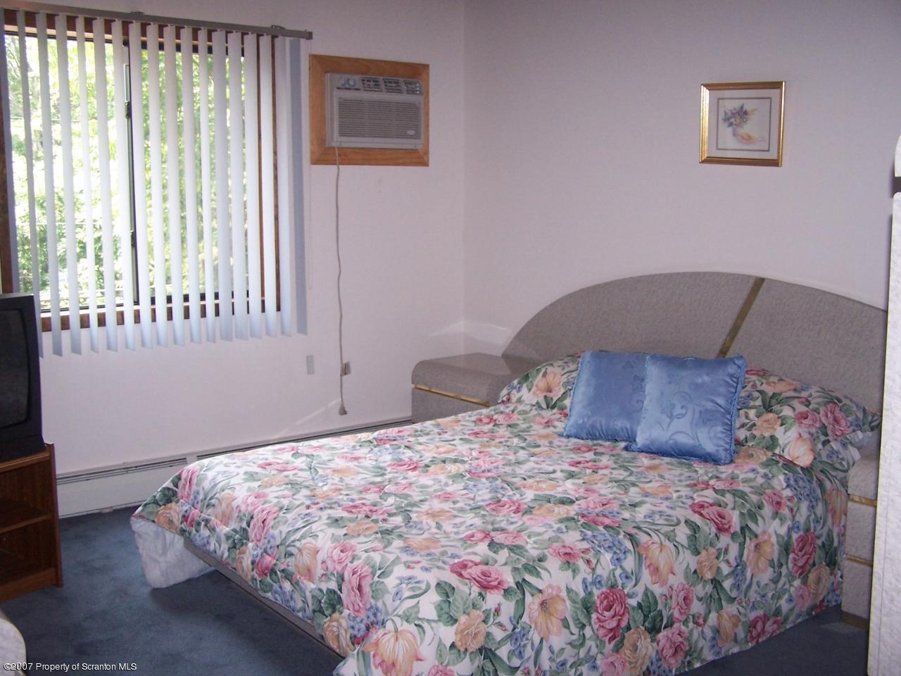 3300 Northgate Road Lake Ariel, PA 18436 - Photo 3 of 11 a large bed sitting in a bedroom next to a window