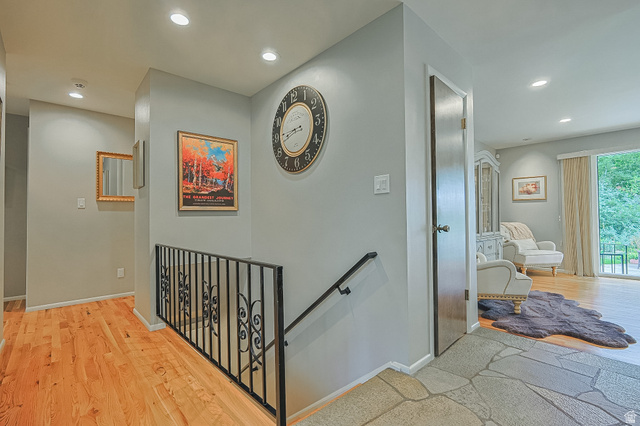 2924 Robidoux Road Sandy, UT 84093 - Photo 33 of 68 Hardwood flooring, recessed lighting, wrought iron railing, sliding glass door, and stone tile entry