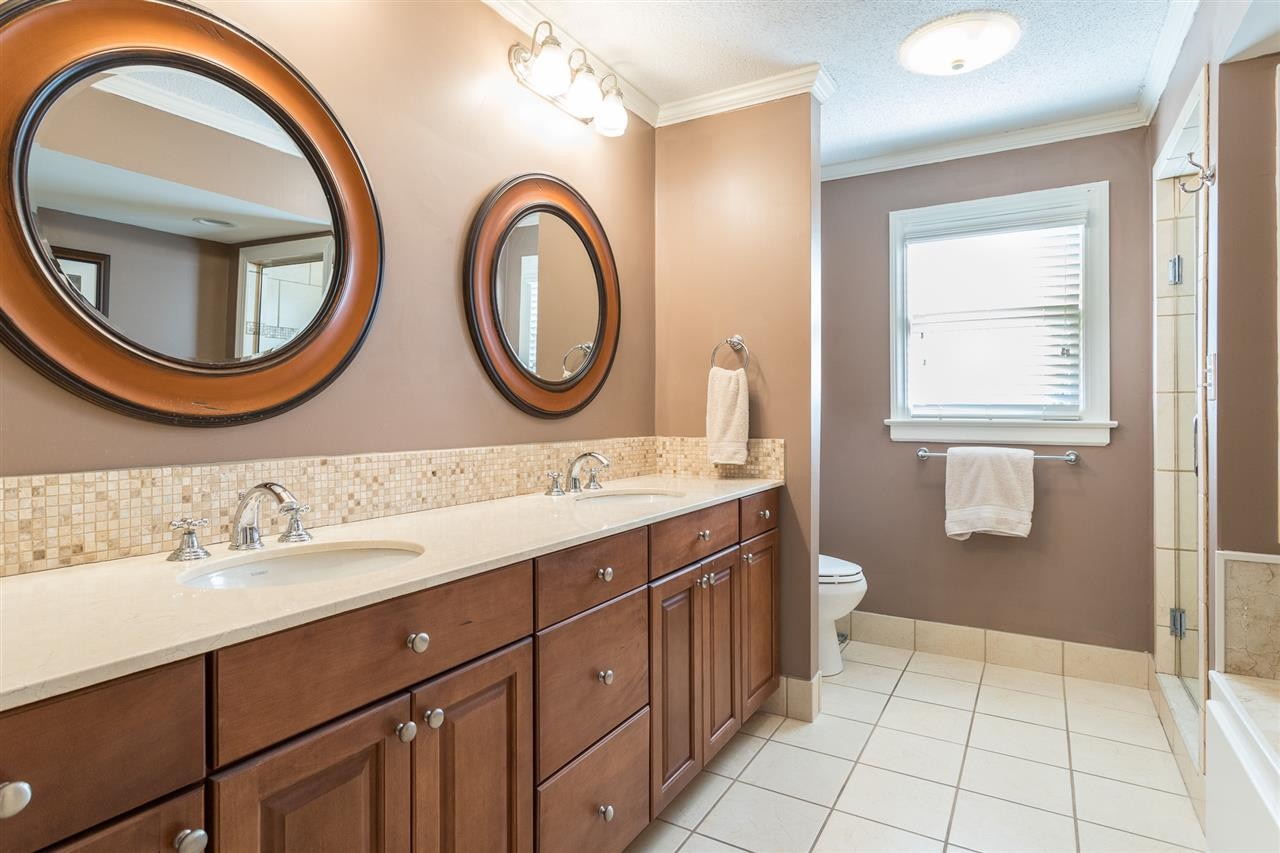 7728 Rainwater Road Raleigh, NC 27615 - Photo 17 of 30 Master bath offers a vanity with double sinks, updated cabinets, new mirrors and tile backsplash. Updated Master Bath