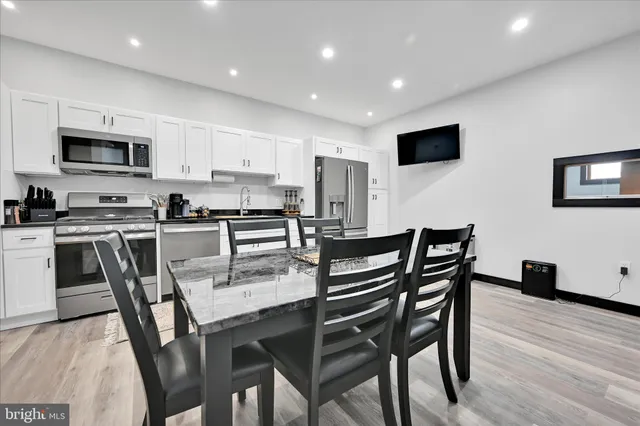 a view of kitchen with cabinets table and chairs