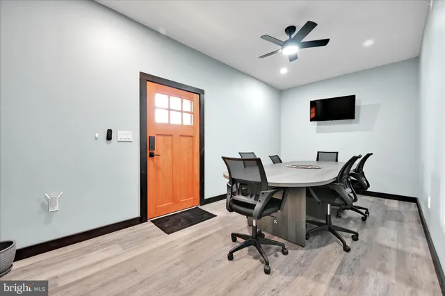 a view of a workspace with furniture and a window