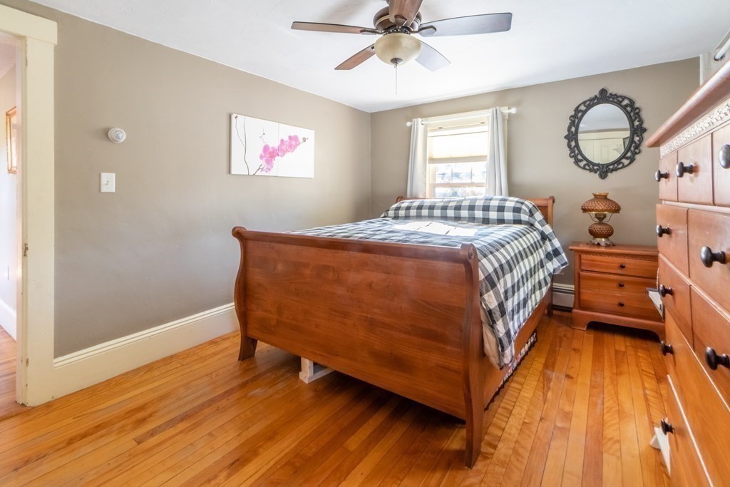 280 Boston Road Chelmsford, MA 01824 - Photo 17 of 24 a bedroom with a bed and a chandelier