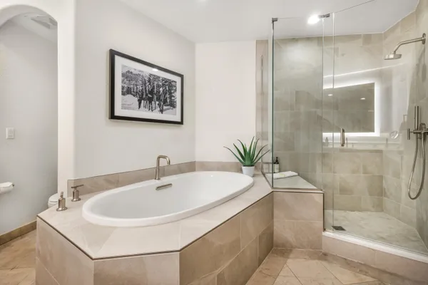 a bedroom with a bed and a night stand