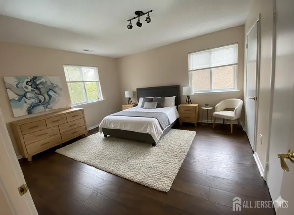 a bedroom with a bed window and couch