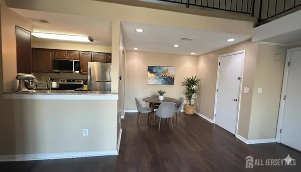 a view of a dining room with furniture and wooden floor