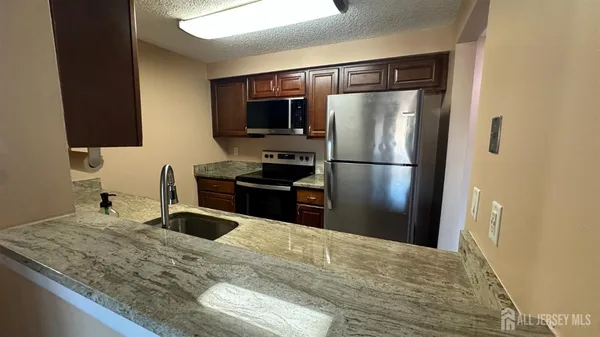 a kitchen with a refrigerator and a sink