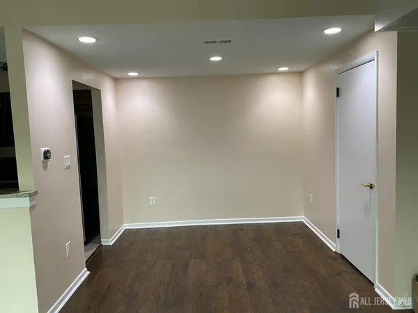 an empty room with wooden floor