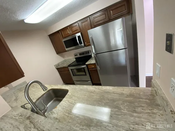 a view of kitchen island sink stove and microwave
