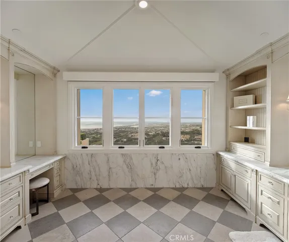a view of hall way with dining room and chandelier