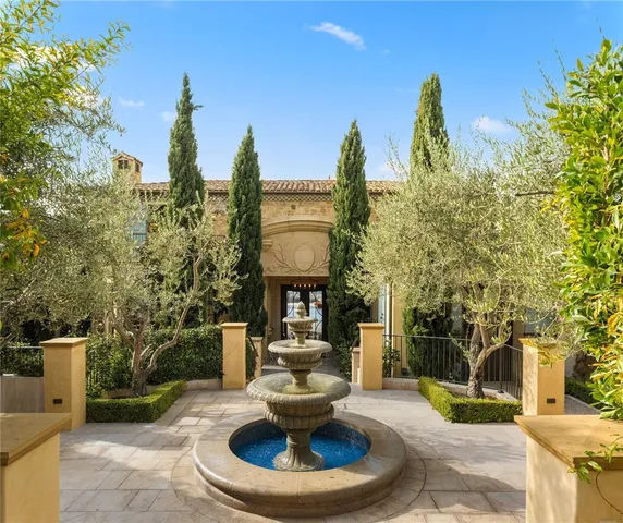a dining room with furniture and large windows