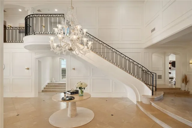 a dining room with stainless steel appliances granite countertop a table chairs and a view of kitchen
