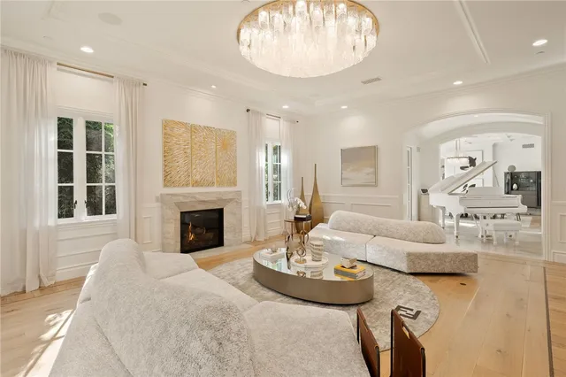 a kitchen with stainless steel appliances kitchen island granite countertop a stove a sink a refrigerator and white cabinets with wooden floor