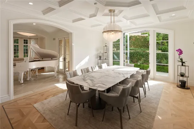 a dining room with furniture and a floor to ceiling window