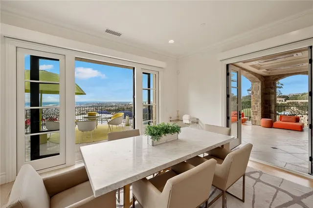 a dining room with furniture a flat screen tv and a floor to ceiling window