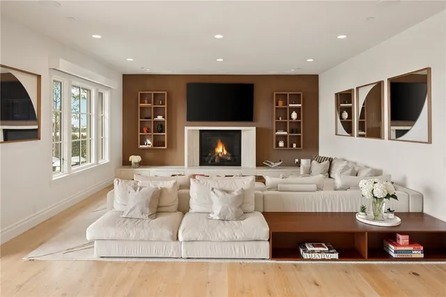 a living room with furniture a fireplace and a chandelier