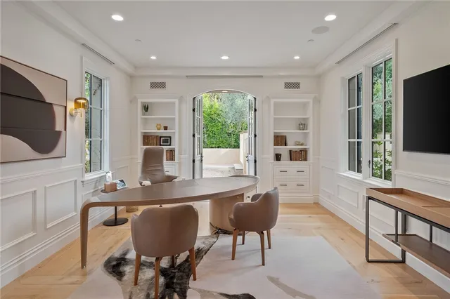 a spacious bedroom with a bed and large windows