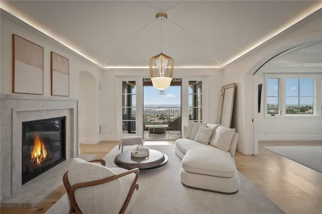 a living room with furniture and a floor to ceiling window