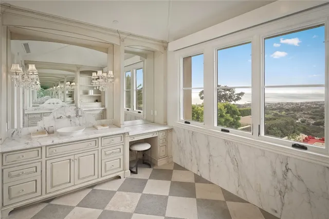 a bedroom with a large bed and a chandelier