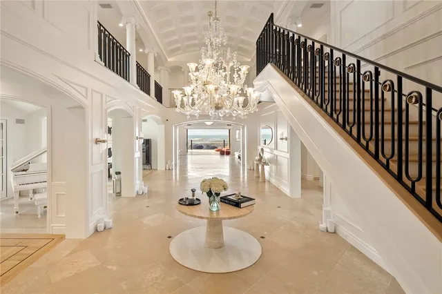 a living room with furniture a fireplace and a large window