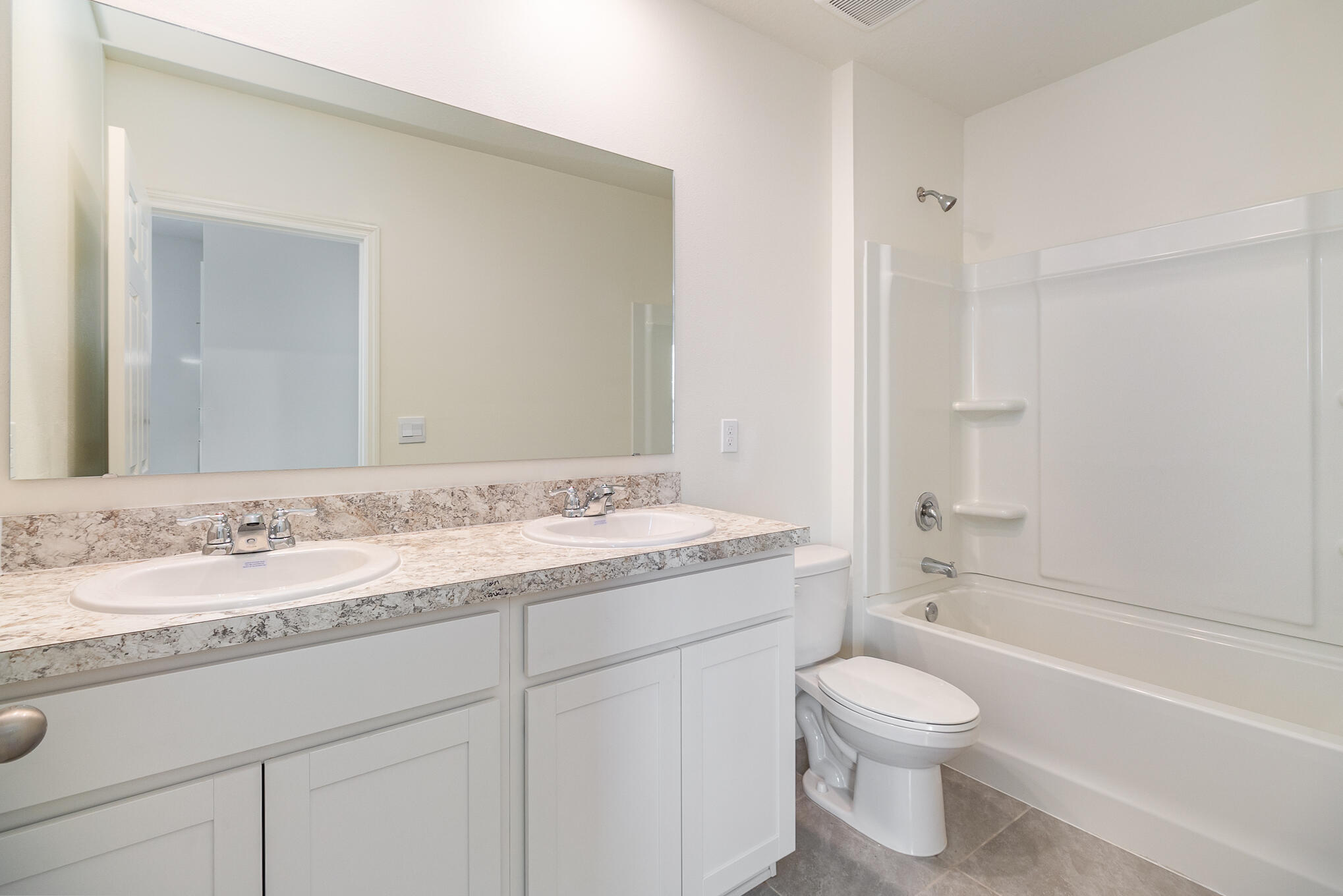 569 Seaspray Drive Fort Pierce, FL 34945 - Photo 15 of 28 a bathroom with a granite countertop sink toilet and shower