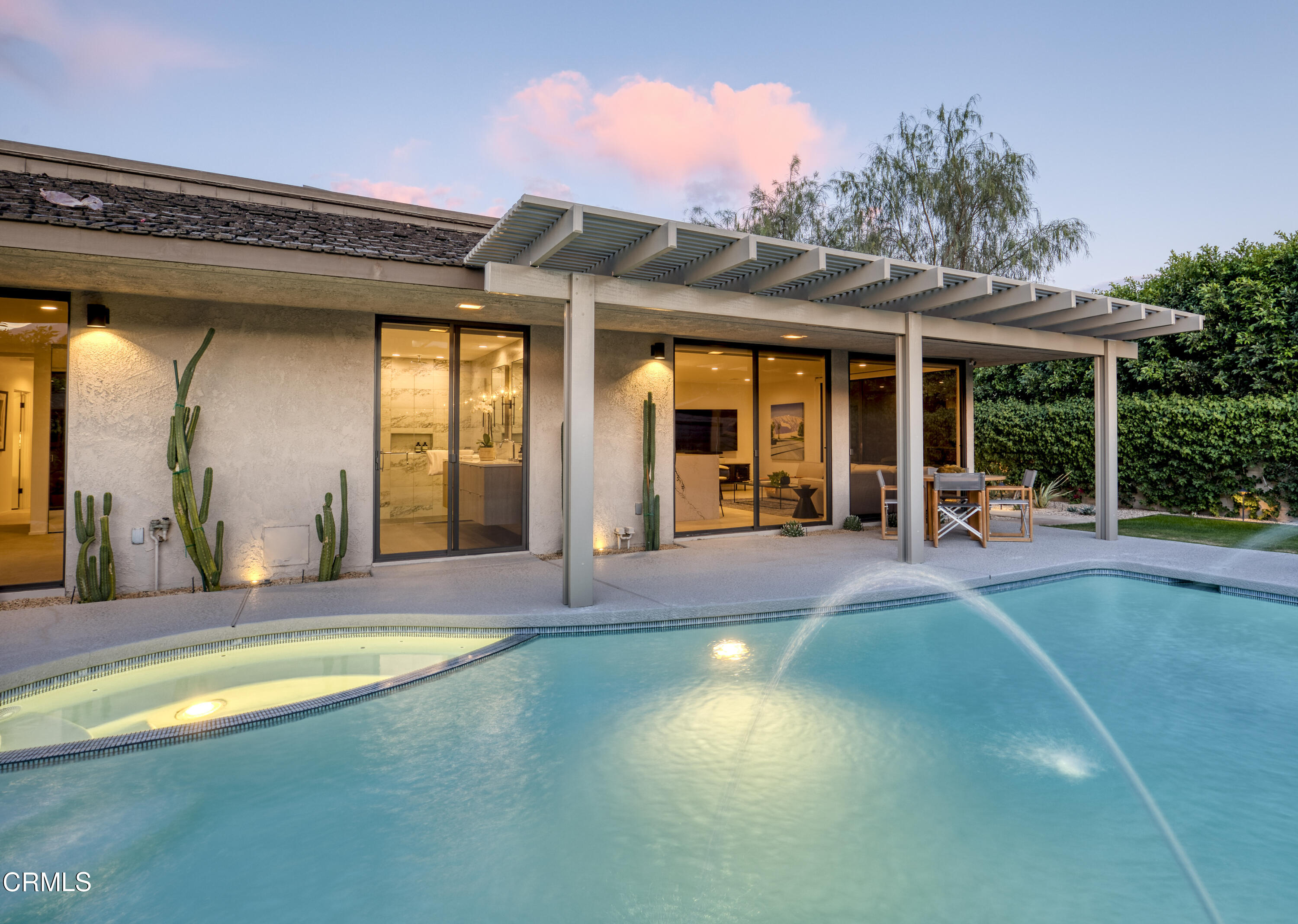 a view of a house with swimming pool and porch with furniture