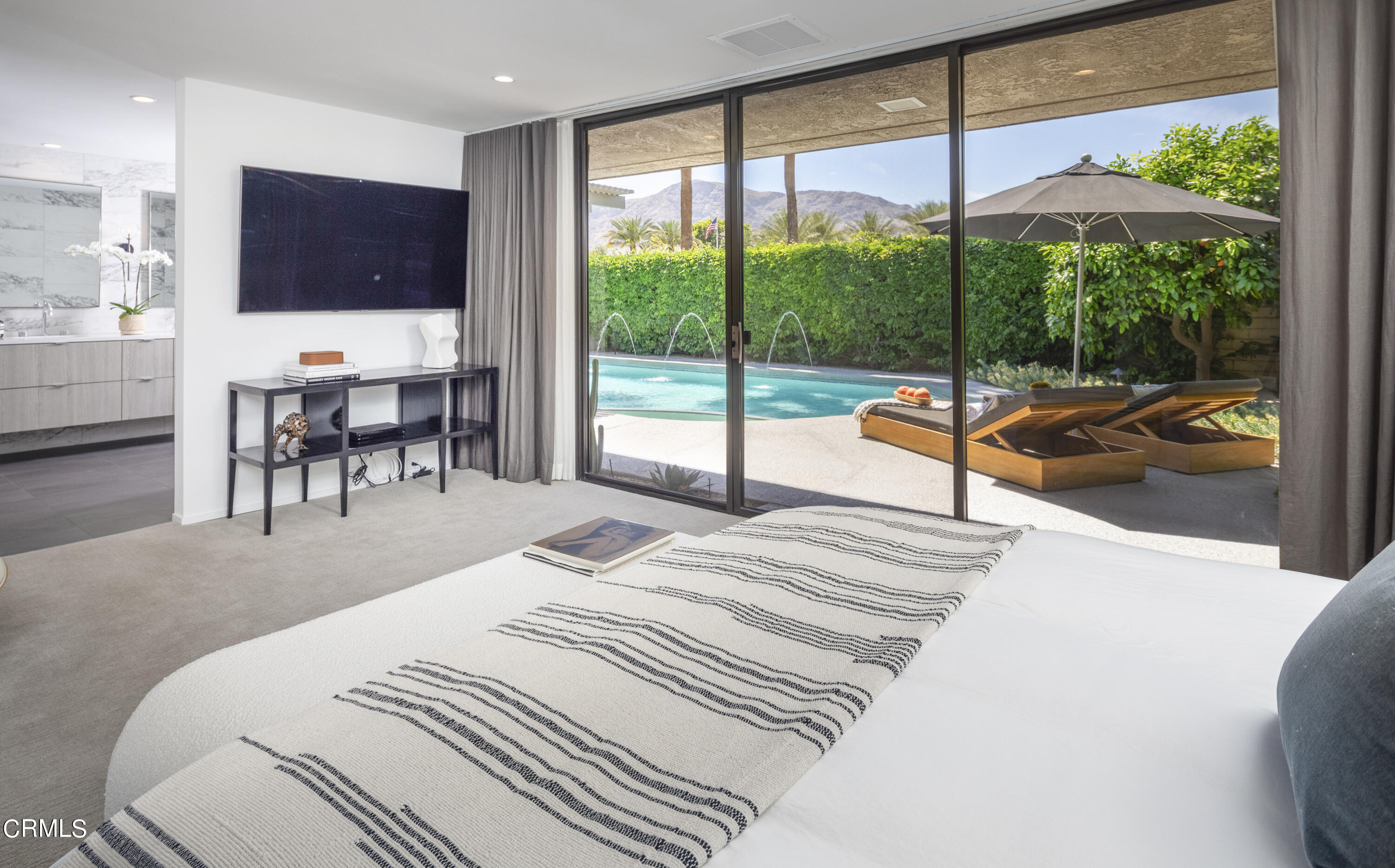 56 Princeton Drive Rancho Mirage, CA 92270 - Photo 16 of 35 a bedroom with a bed and large window with balcony view