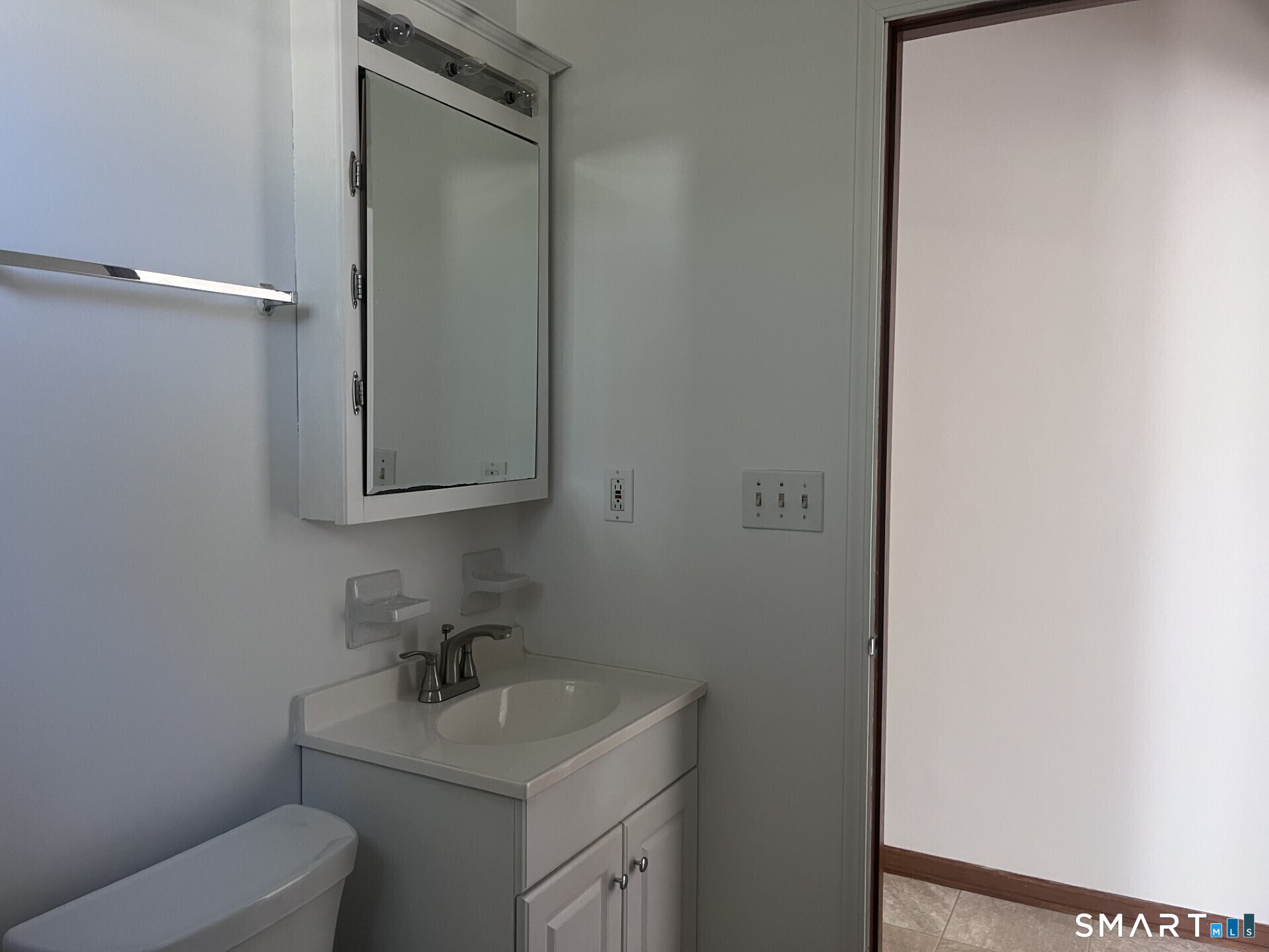 124 Thorpe Street Fairfield, CT 06824 - Photo 16 of 23 a bathroom with a sink toilet and mirror