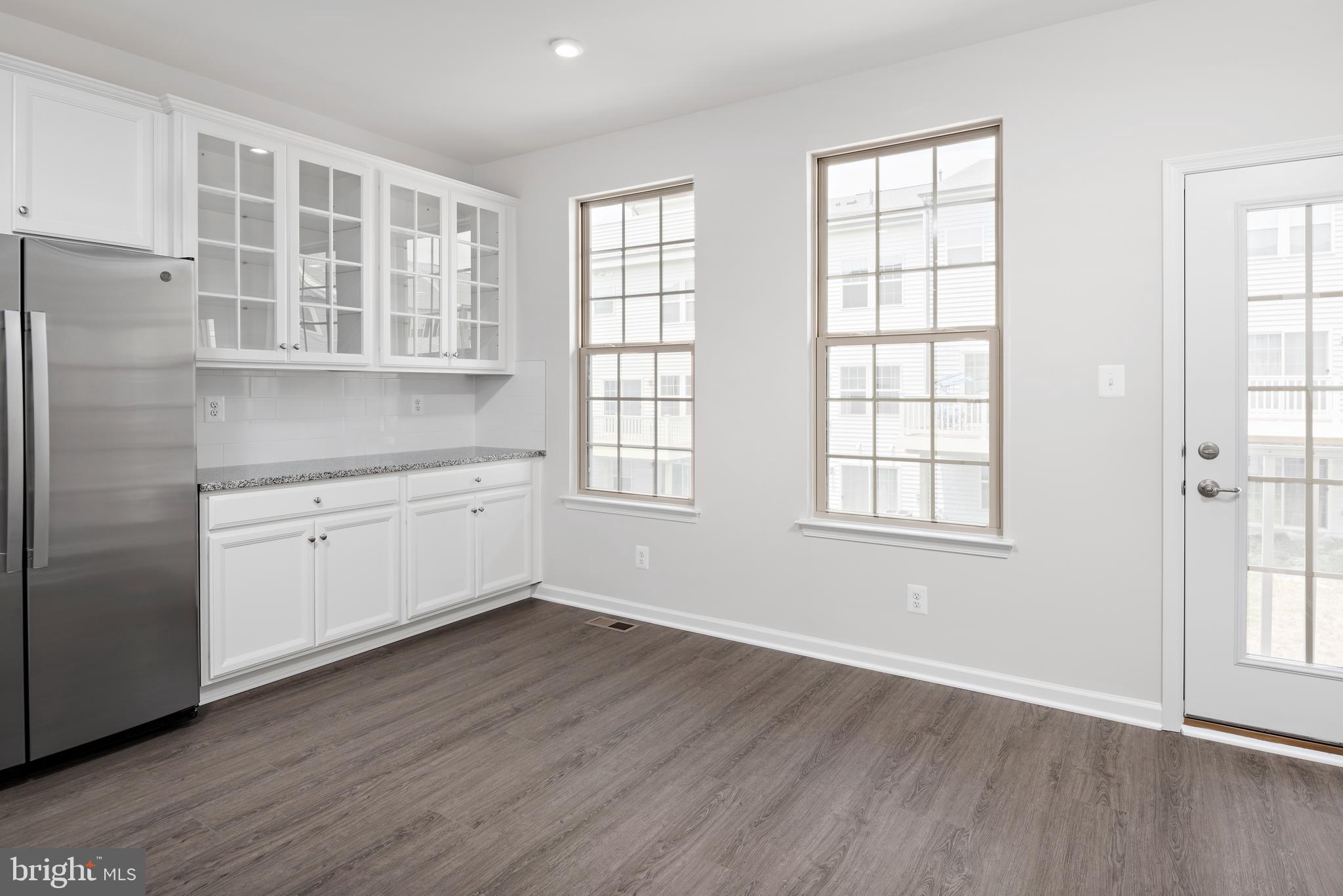 59 A Destrier Street Ranson, WV 25438 - Photo 7 of 17 an empty room with wooden floor and windows