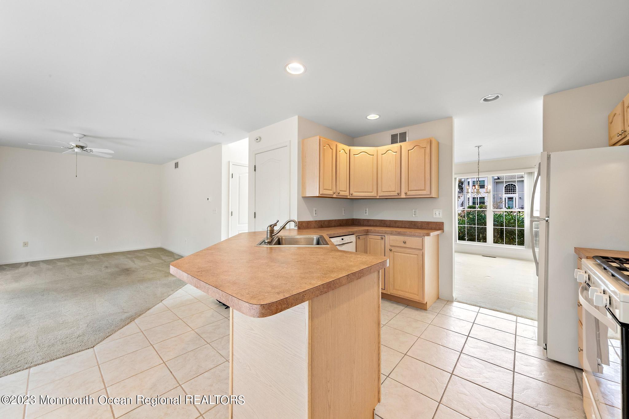 135 Barracuda Road Manahawkin, NJ 08050 - Photo 13 of 47 a kitchen with a sink a stove a refrigerator and cabinets