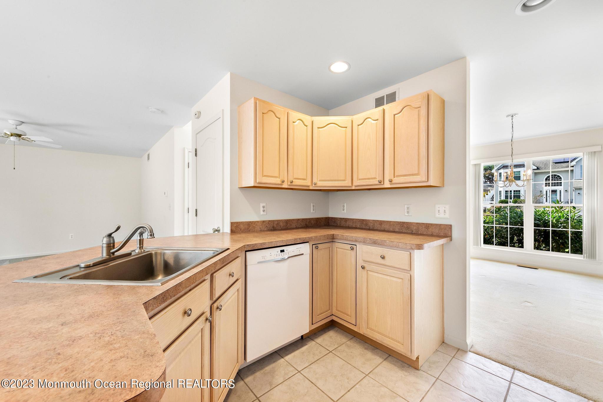 135 Barracuda Road Manahawkin, NJ 08050 - Photo 14 of 47 a kitchen with stainless steel appliances granite countertop a sink and a white cabinets