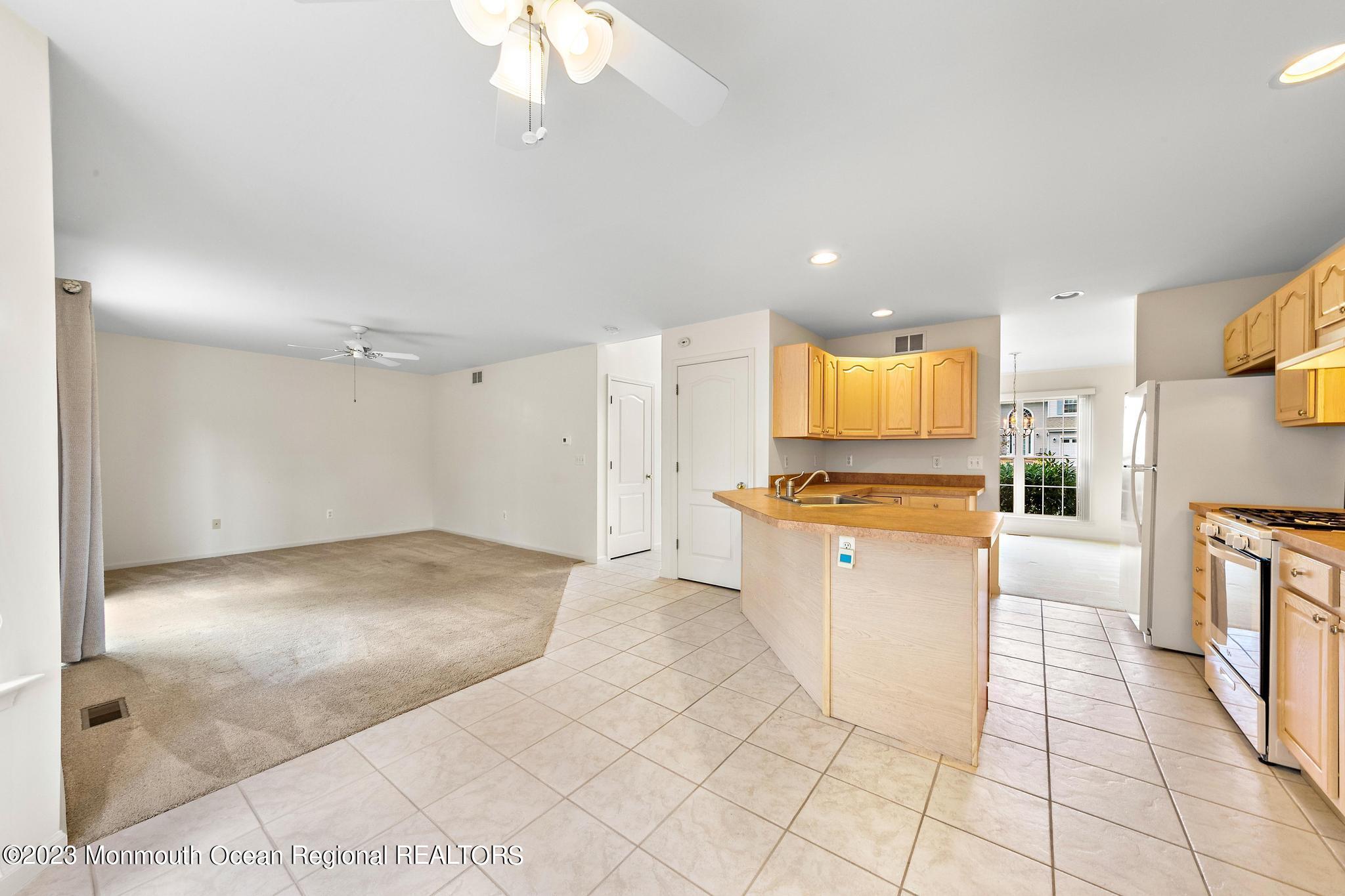 135 Barracuda Road Manahawkin, NJ 08050 - Photo 17 of 47 a kitchen with granite countertop a stove a sink and a refrigerator
